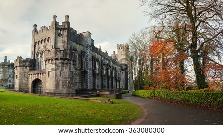 Kilkenny Castle and gardens in autumn with heavy clouds. It is one of the most visited tourist sites in Ireland