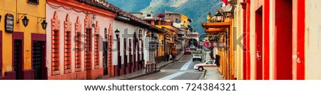 San Cristobal, Mexico. Streets in the cultural capital of Chiapas - San Cristobal de las Casas, Mexico. Spanish colonial layout and architecture. Mountains at the background