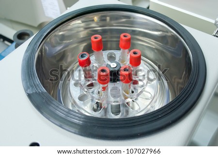 technician add blood tube in to centrifuge for separate serum out of red blood cells