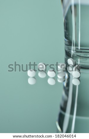 pills and drink water on mirror reflection