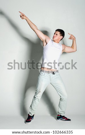 Young bodybuilder in a white shirt posing