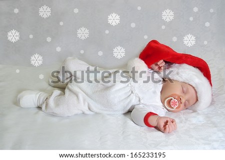 Sleeping christmas newborn baby in  Santa Claus red hat. Photo for calendar, card