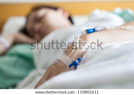 Close up of a woman patient in hospital with saline intravenous (iv)