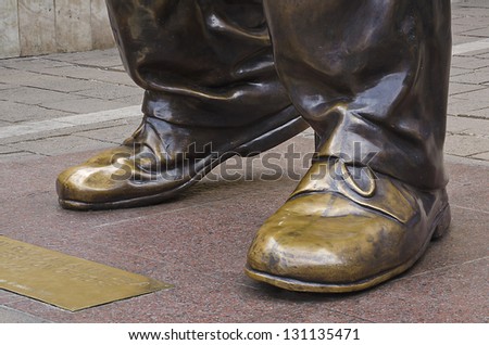 JOHANNESBURG - MARCH 10: Bronze shoes of statue of Nelson Mandela stands on March 10, 2013 in Johannesburg.  Mr Mandela is credited with peacefully leading South Africa across the apartheid divide.