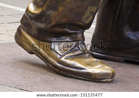 JOHANNESBURG - MARCH 10: Bronze shoes of statue of Nelson Mandela stands on March 10, 2013 in Johannesburg.  Mr Mandela is credited with peacefully leading South Africa across the apartheid divide.