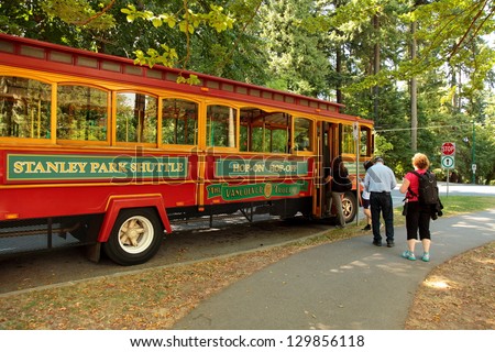 VANCOUVER - AUGUST 24: The hop-on hop-off shuttle in Stanley Park, Vancouver picks up tourists on August 24, 2012. The 1000 acre park attracts thousands  of tourists each year.