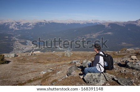 hiker looking over  from the top of Whistlers mountain onto Jasper Alberta