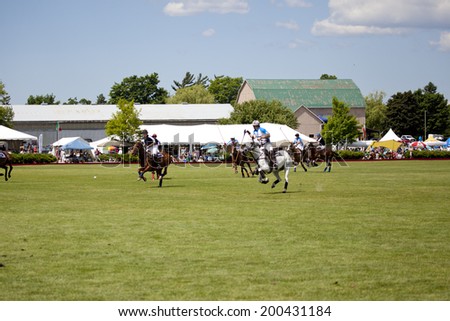 TORONTO - JUNE 22, 2014: Polo match between two teams at the Polo For Heart fundraiser in Toronto. Polo For Heart has raised more than $5 million for heart and stroke related charities.