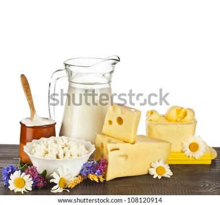 dairy products on the wooden table isolated on white background