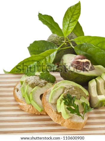 Sandwich with avocado on a wooden strip board