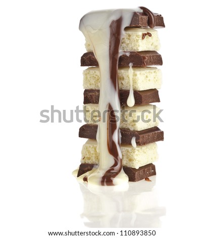 stack of chocolate pieces with creamy syrup poured on on white background