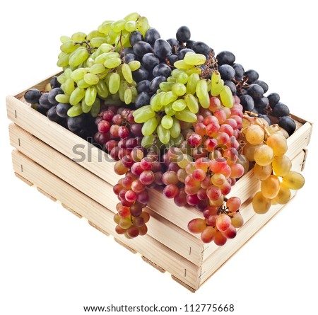 colorful mixed grapes in a wooden crate box isolated on a white background