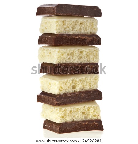 stack of chocolate and milk pieces on  white background