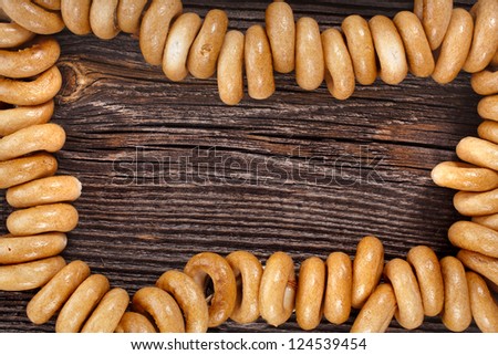 Border frame of sheaf bagels on old ancient wood texture