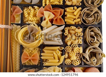 Italian pasta collection in wooden box surface top view background