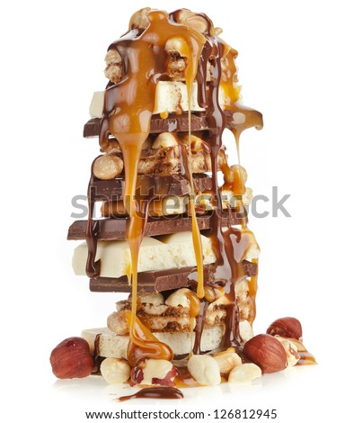 Tower stack of Chocolate  pieces  and caramel syrup poured on white background