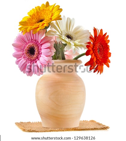 Bouquet flowers gerbera in a wooden vase on a white background