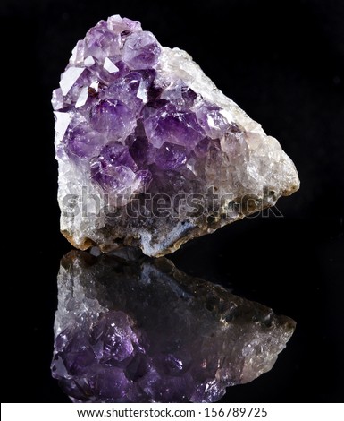 Natural cluster of Amethyst, violet variety of quartz close up macro with reflection isolated on black background