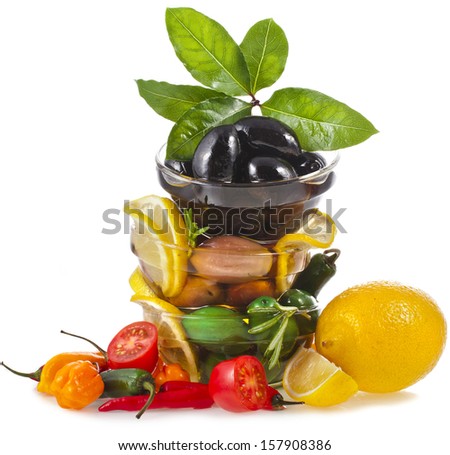 tower olives dish with vegetables, herbs, spices isolated on a white background