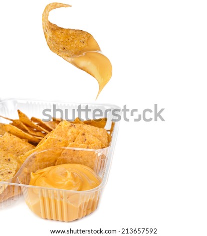 nachos chips with cheese sauce in plastic container on white background