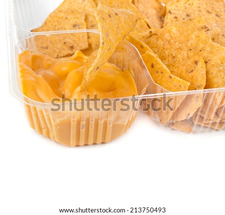 nachos chips with cheese sauce in plastic container isolated on white background