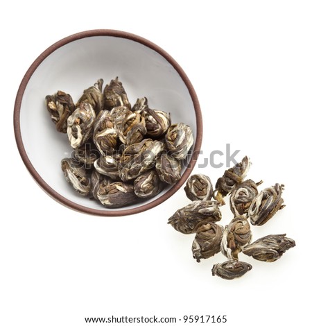 Oriental clay tea cup  with green  tea leaves isolated on white background