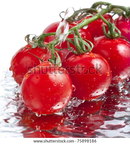 fresh tomatoes with pouring water isolated on white background
