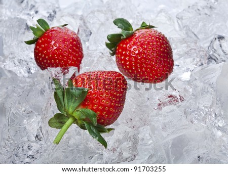 Sweet strawberries in  ice cubes with  mint leaf on white background