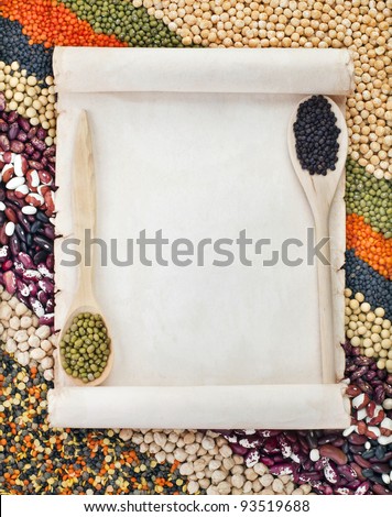 old paper for menu on lentils, beans, peas, soybeans, legumes with spoons textured background
