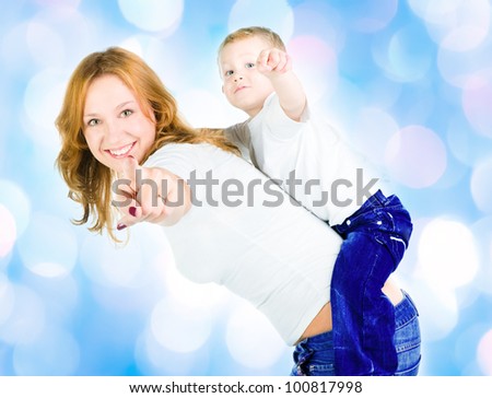 Mother and son point out   with blue lights in the background