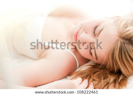sexy blond woman sleep on bed in lingerie