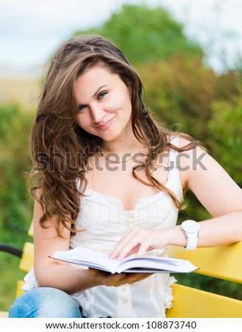 beautiful woman read a book in park