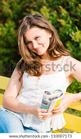 Woman read a magazine in park