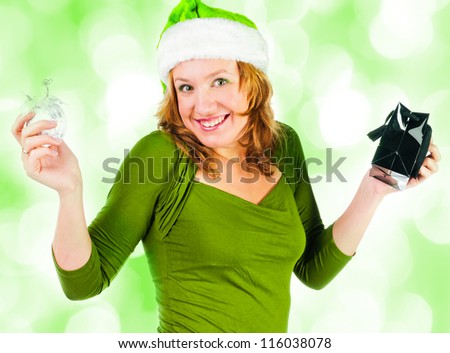 Beautiful happy woman looking inside black shopping gift bag looking surprised.