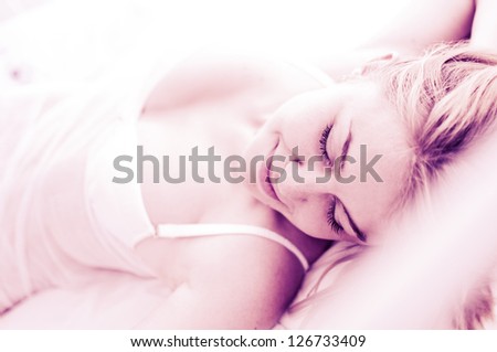 sexy blond woman sleep on bed in lingerie