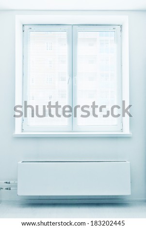 White plastic double door window with radiator under it. Domestic room.