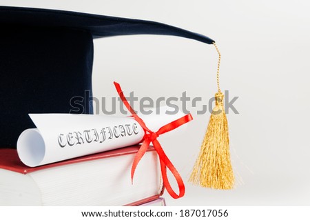 Graduation cap with book and diploma