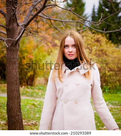 Beautiful young woman in autumn forest