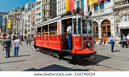 ISTANBUL, TURKEY - AUGUST 27 2013: Retro tram moves along a busy Istiklal street in Istambul.  It is the most famous street in Istanbul, visited by nearly 3 million people in a single weekends day