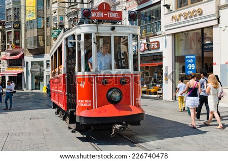 ISTANBUL, TURKEY - AUGUST 27 2013: Retro tram moves along a busy Istiklal street in Istambul.  It is the most famous street in Istanbul, visited by nearly 3 million people in a single weekends day