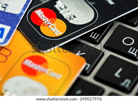 YEKATAERINBURG, RUSSIA - JAN 07, 2015:  Shopping on the Internet - Visa card and Mastercard on the notebook keyboard.