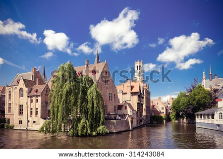 medieval houses, Rozenhoedkaai in Brugge, Dijver river canal and Belfort (Belfry) tower, West Flanders. Instagram style filtred image