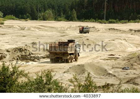 Open cast mine pit/ One truck,full, goes up and another,empty, goes down.