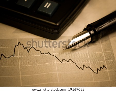 Economic crisis. Business concept. The calculator, pen and diagram.