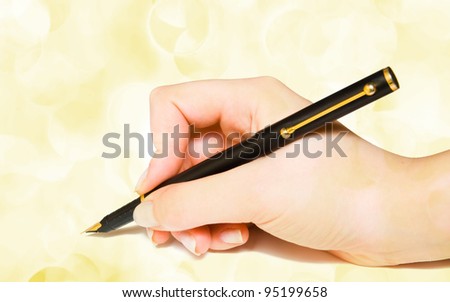 pen in the hand on holiday lights