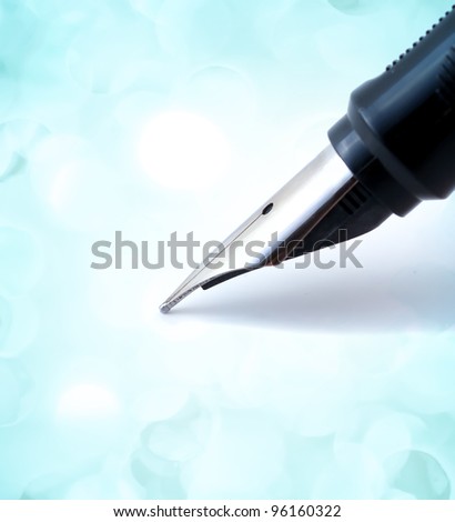 Close-up of a fountain pen with lights in the background