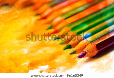 Color photo of a set of pencils on watercolor
