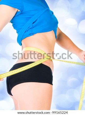 woman diet concept with measuring tape  with blue lights in the background