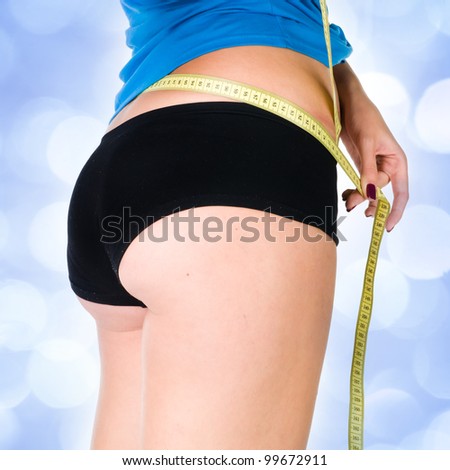woman diet concept with measuring tape  with blue lights in the background
