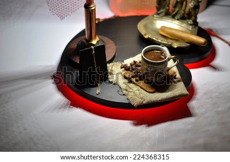 Message from the seal of sealing wax, a cup of coffee and a copper ashtray with monkeys